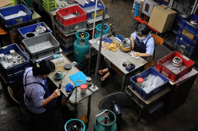 Employees working on pewter at the Royal Selangor Visitor Centre, Selangor, Malaysia