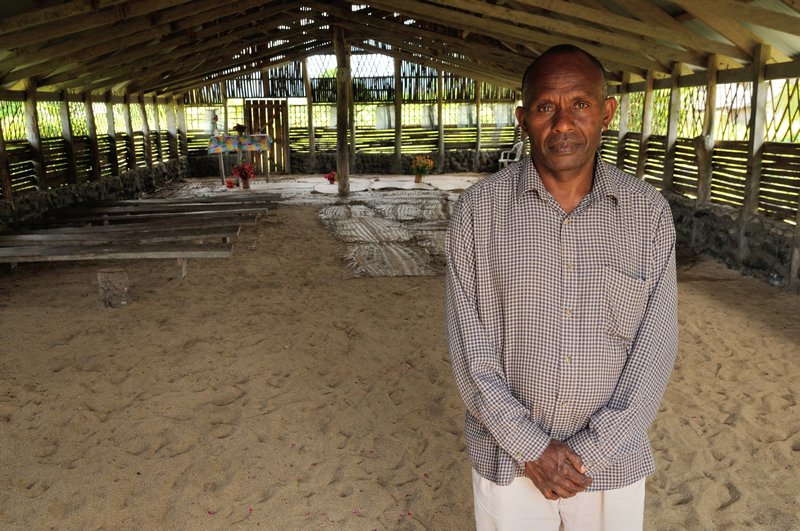 Pastor David of the Apostle David Ministry stands within his church - Tanna Island, Vanuatu