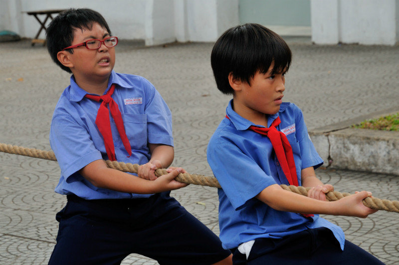 School children wrestle in a tug of war contest - Ho Chi Minh City, Vietnam