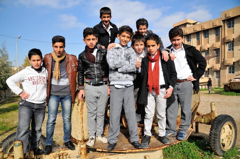 Boys posing on disused weaponry - Amna Suraka, Sulamaniyah, Kurdish Region of Iraq