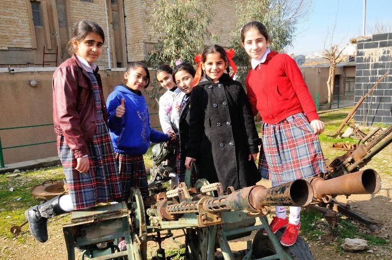 Girls posing on disused weaponry - Amna Suraka, Sulamaniyah, Kurdish Region of Iraq