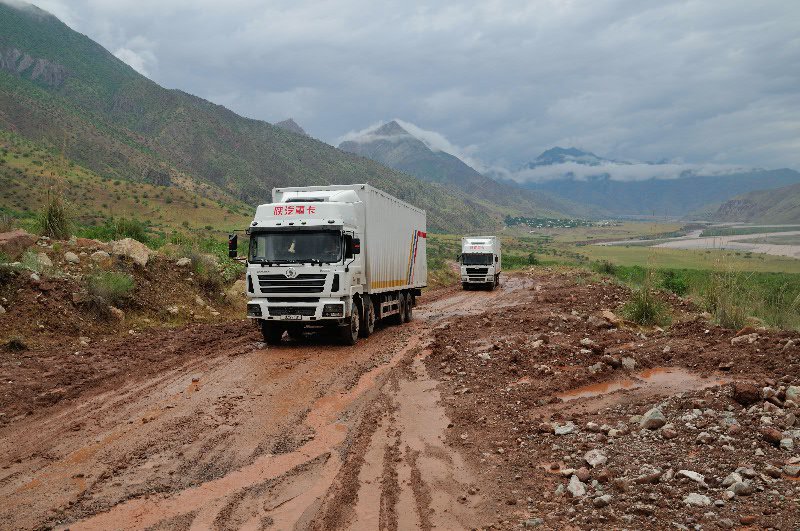 Chinese trucks ply the muddy road - near Shurabad Pass, Tajikistan