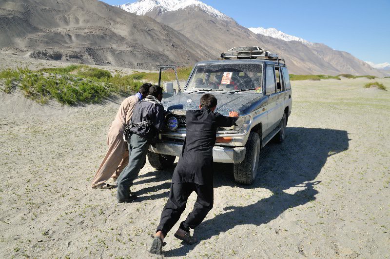 Pushing the broken Landcruiser to higher ground - Afghanistan
