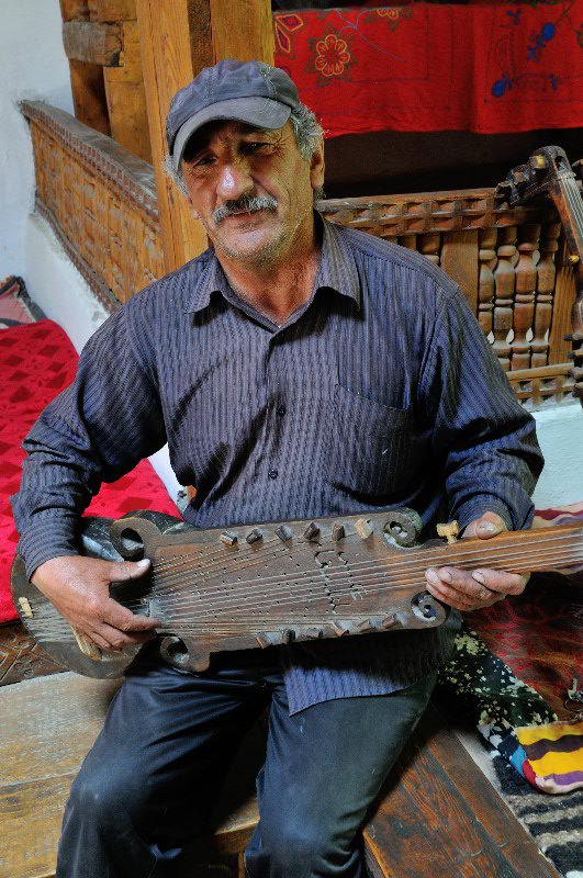 Aydarmamad with a traditional Tajik instrument - Yamg, Tajikistan