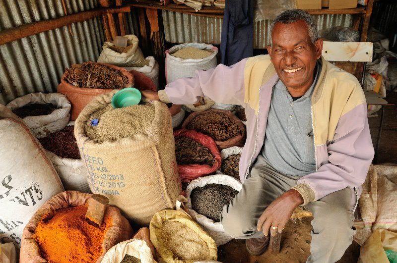 Friendly spice seller at market - Axum, Ethiopia