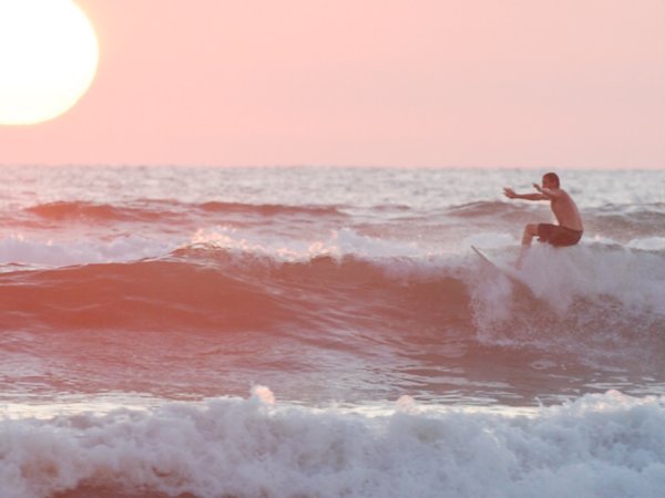 Ry surfing at sunset