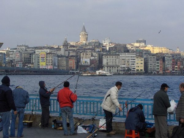 Fishermen On The Golden Horn, Galata Tower Is In The Background