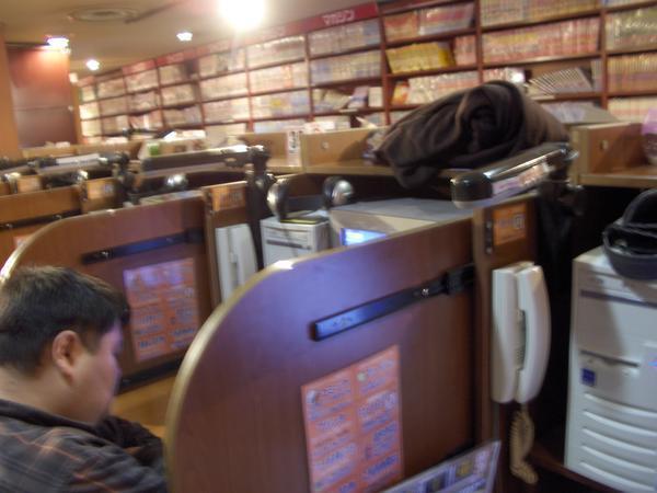Guy sleeping at internet cafe