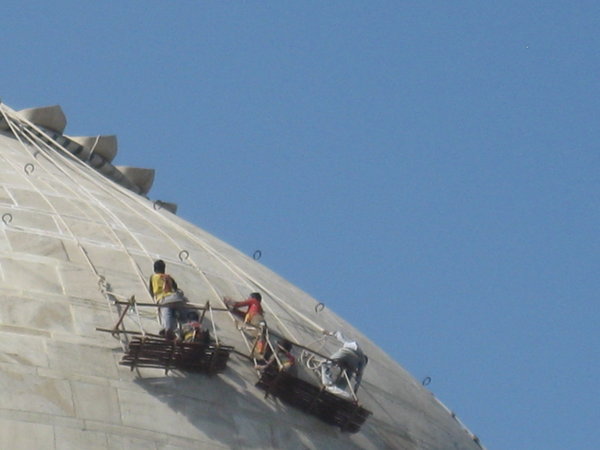 Workers Fixing dome of Taj