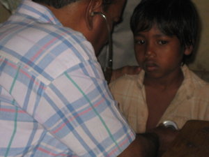 Dr. checking child with stethoscope