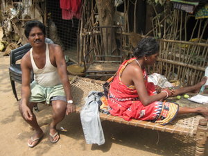 People relaxing outside huts