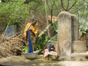Women washing cloths at outdoor water source