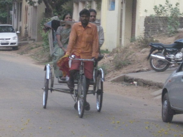 Bike Rickshaw delivering couple to home