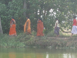 Colorful Saris on women walking along backwaterh path