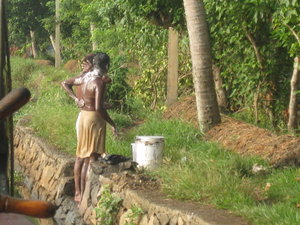Man soaping up for a bath in the backwaters