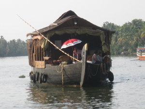 Passing houseboat with umbrella 