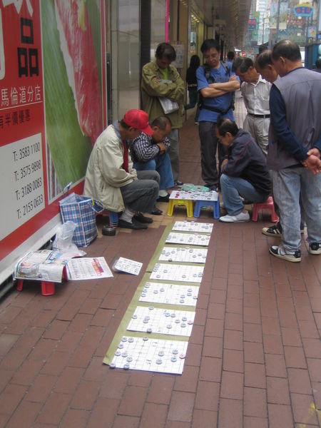 Men playing draughts in street x