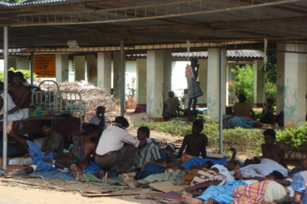 Patients lying in makeshift shelters