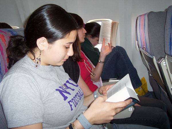 The 3 girls reading on the plane..