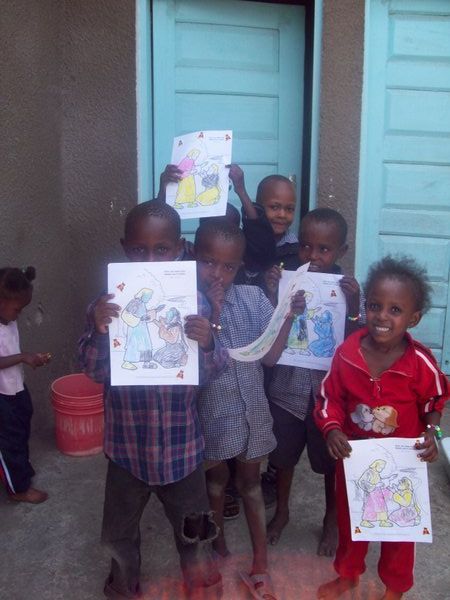 showing off their coloring pages