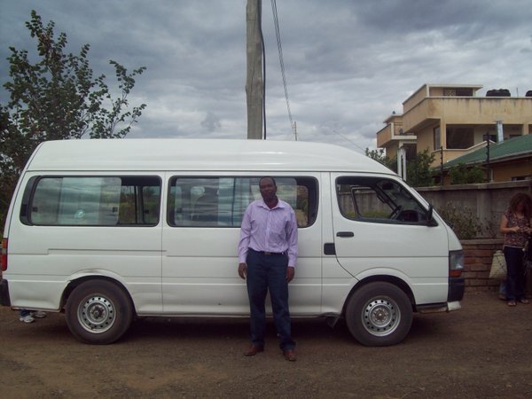 Our Trusty driver, Kamarabi, and our bus.