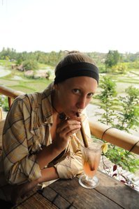 Elly sipping on a lemonade in the rice fields