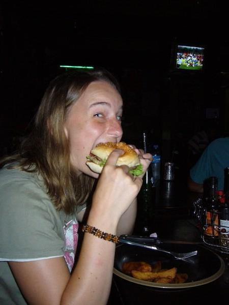 Louisa eating a burger in an Irish pub