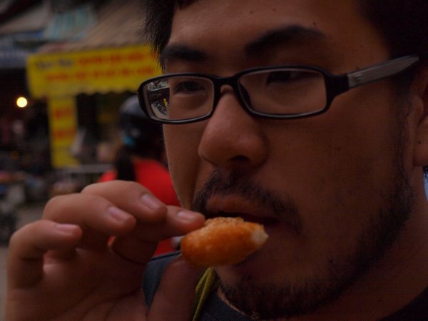 the first tenacious bite of some street food- very yummy