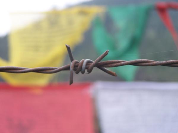 Buddhist Flags and Barbed Wire
