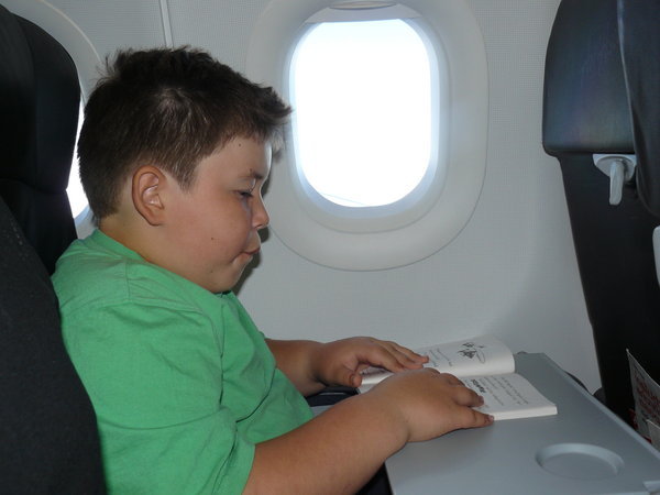 one for Miss Crofsky, Jack doing homework on the plane to Chiang Mai