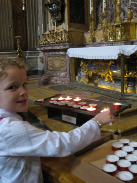 Sarah Lighting a candle at the Basilica