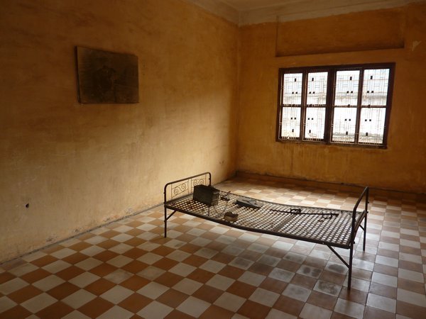 S21 prison.  The picture on the wall is the body that was discovered here, chained to that same bed
