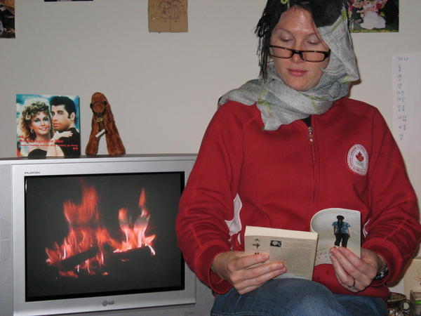 Kim reading by the fire