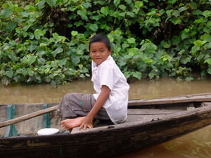 A boy taking a boat ride with his father