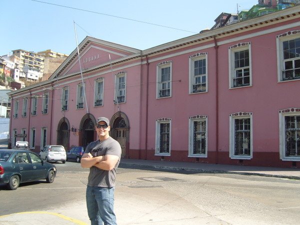 Staying strong in front of a pink building