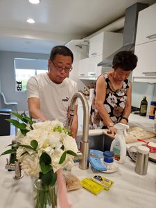 The day after the wedding at Will and Mercy's apartment with her parents preparing Chinese dumplings