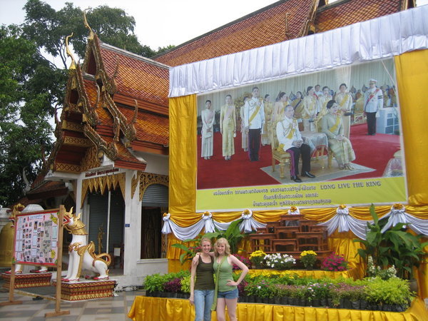 Tamara & Rosanna in front of billboard of the Royal Family
