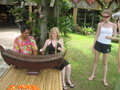 Rosanna learning to play the Thai version of a xylaphone while Tamara watches