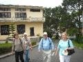 Ruth, Johnny, Bob, and Barb arrive at the Dalat School campus climbing the long hill