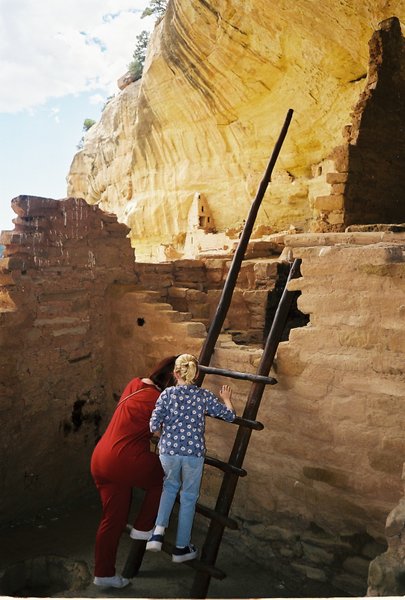 Linda and Rosanna climbing cliff dwellings