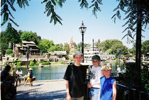 Tamara, Rosanna, and Will in front of Tom Sawyer's Island at Disneyland