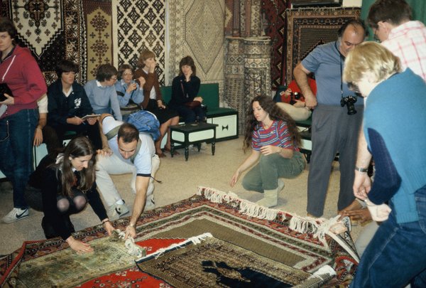 Linda in center background as tourists examine the rugs