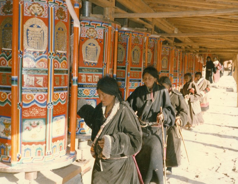 Pilgrims spinning prayer wheels in Lhasa