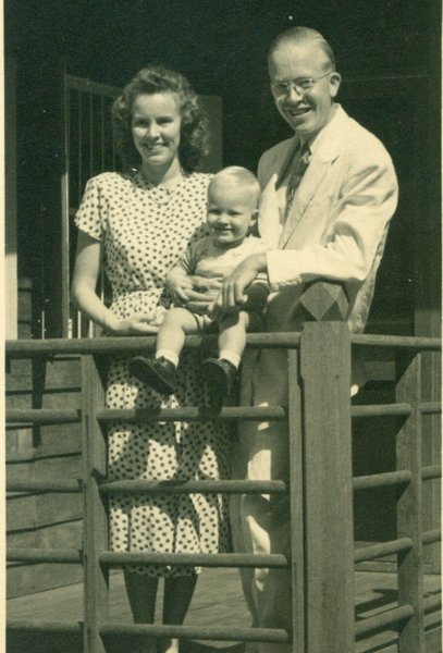 Bob with Mom and Da on porch of home in Korat
