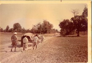 Dad walking behind oxcart on his way to a village to preach