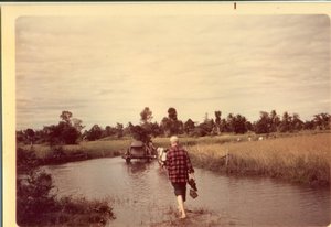 Dad wading across streams to get to villages