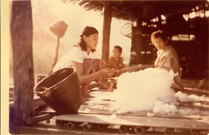 Villagers ginning cotton