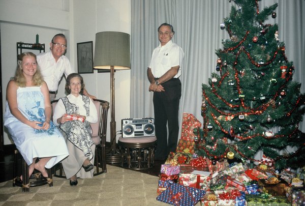 Carol, Dad, Mom, and Uncle Wayne ready to open presents on Christmas morning
