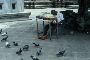 Sleepy vendor at the Temple of the Emerald Buddha