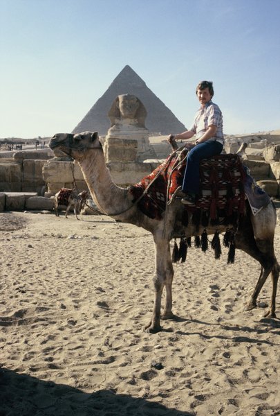 Bob on camel in front of the Sphinx and a pyramid